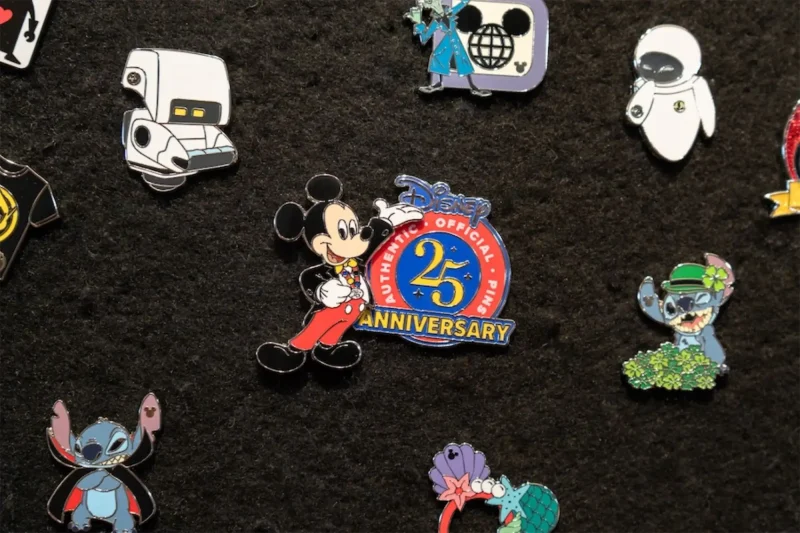 Mickey Mouse 25th Anniversary pin surrounded by several others