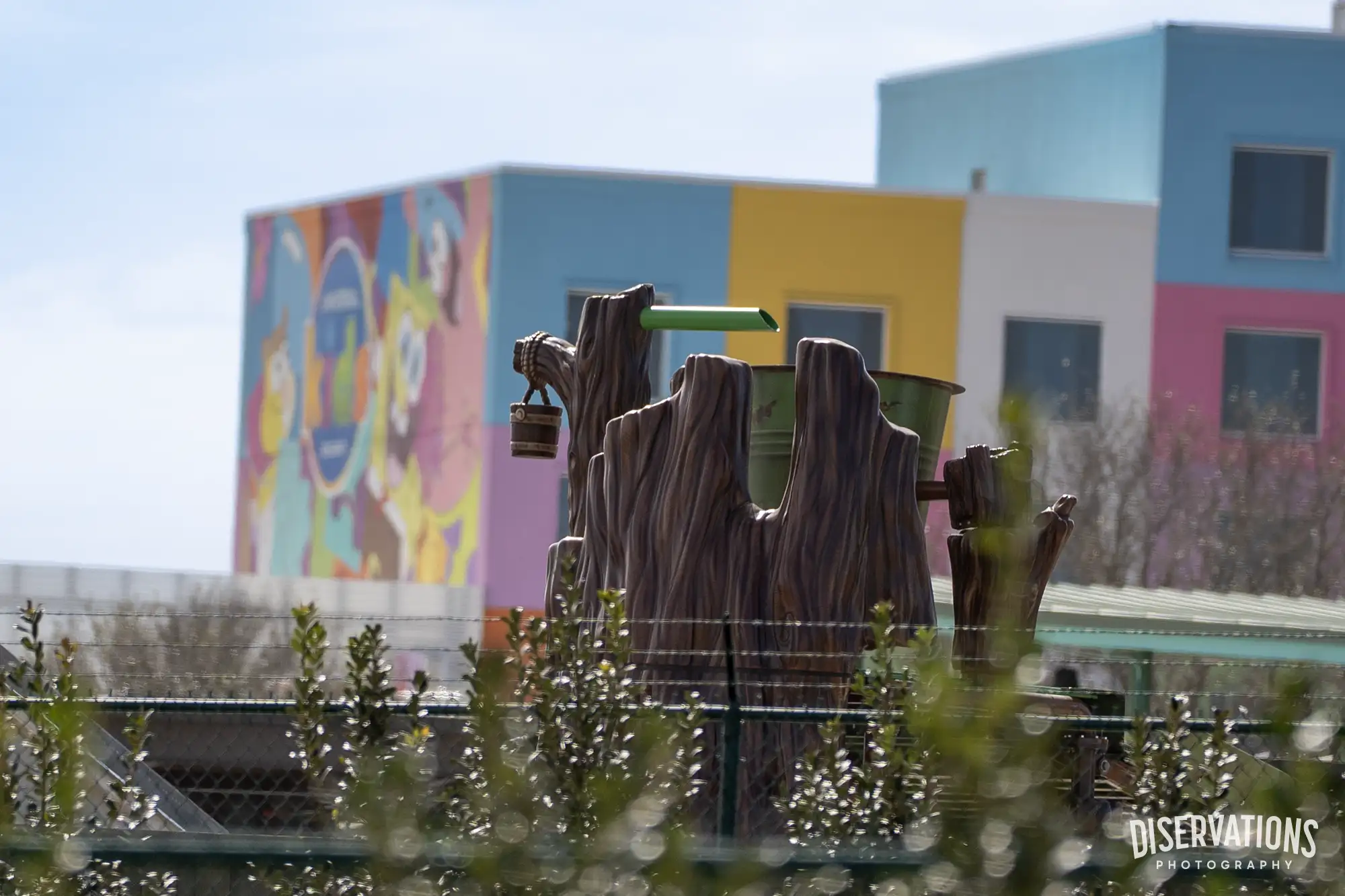 A Shrek water playground in front of the Universal Kids Resort Hotel, featuring a SpongeBob mural