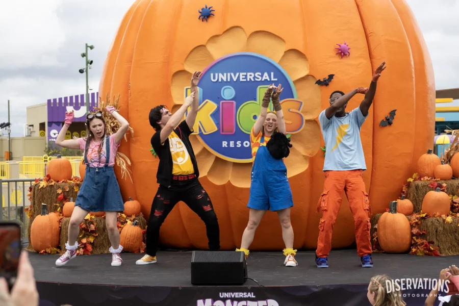 The cast of Monster Tots Superfan Spooktacular and an enormous pumpkin