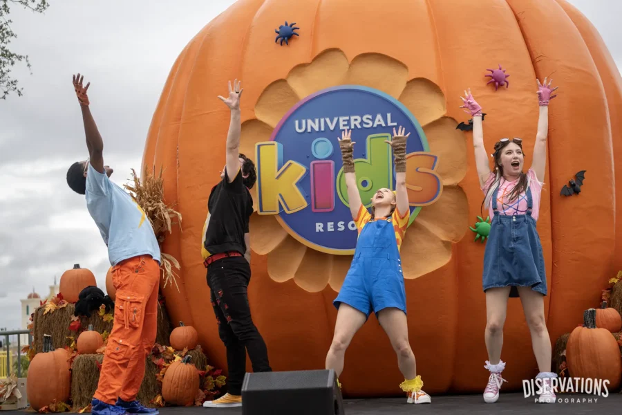 The cast of Monster Tots Superfan Spooktacular jumping in the air