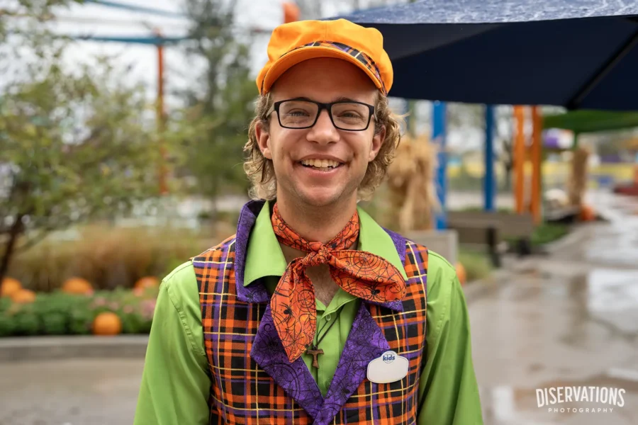 A Universal Kids Resort Team Member models his Halloween outfit, complete with orange hat and scarf