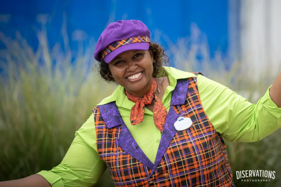 A Team Member showing off her Halloween vest, scarf, and hat